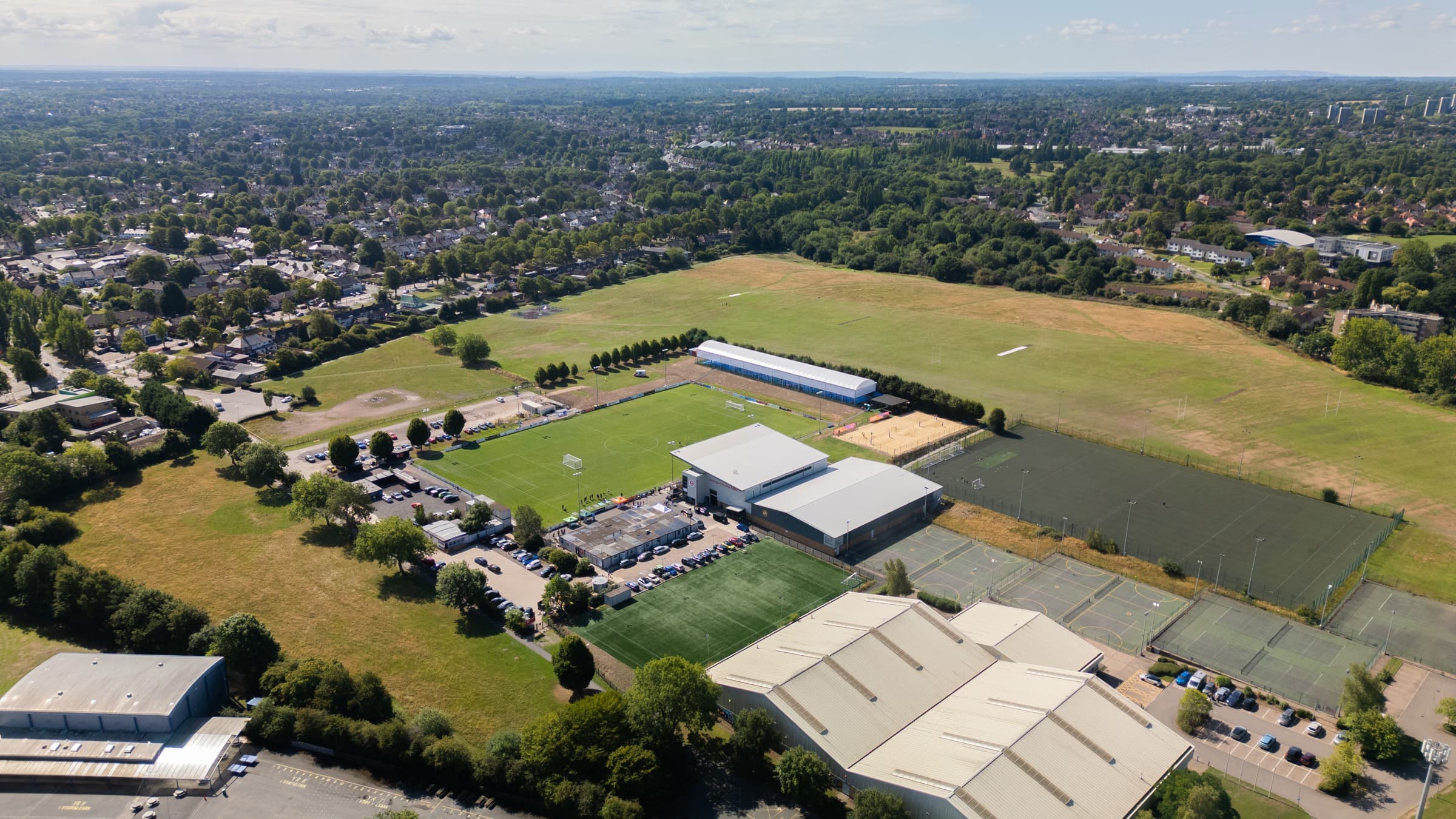 Aerial view of Birmingham Sporting Village — the main pitch, grandstand, clubhouse and grounds at Birmingham Moseley Rugby Club