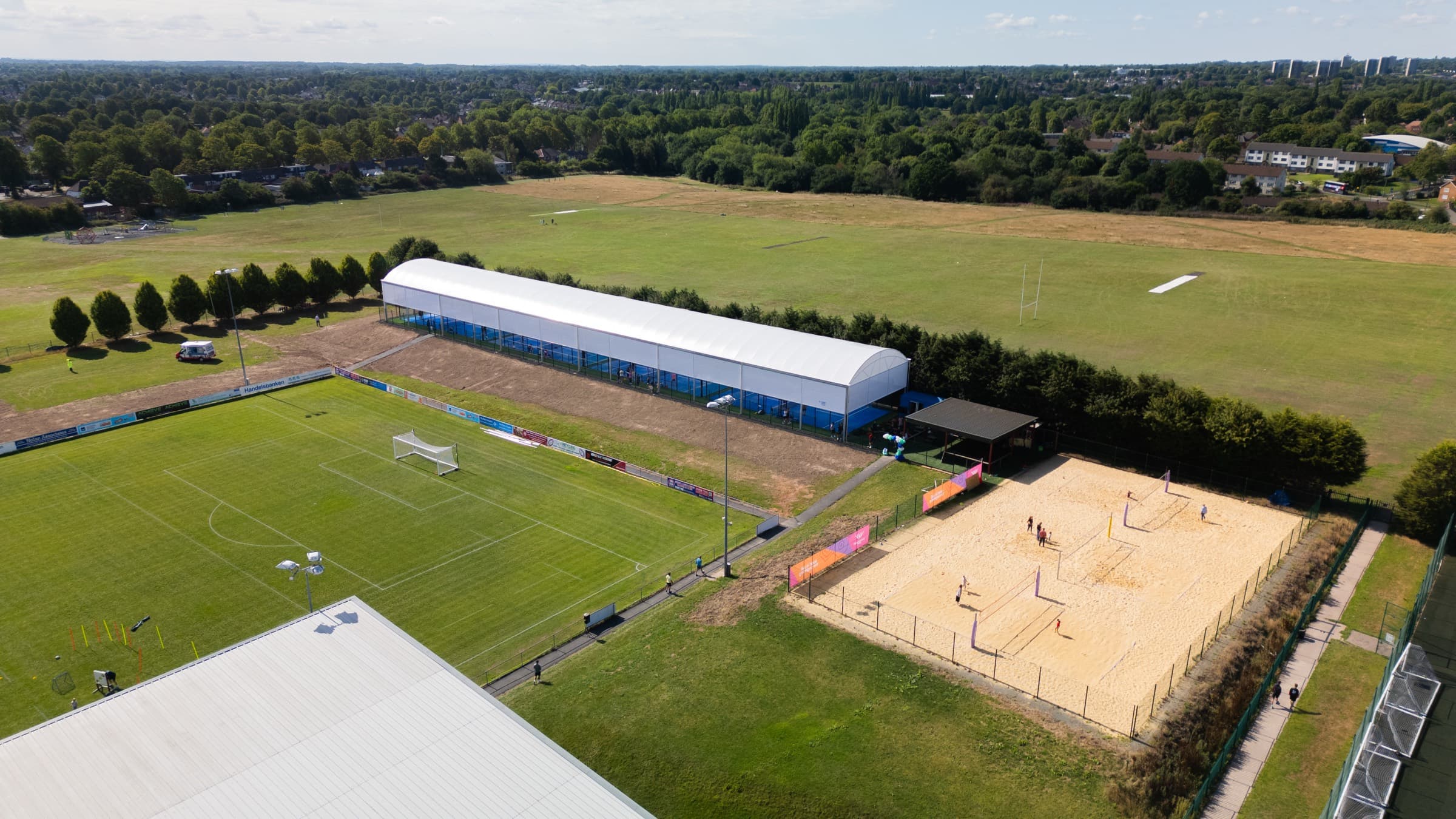 Aerial view of the sporting village — the padel dome, Commonwealth beach volleyball courts and pitches