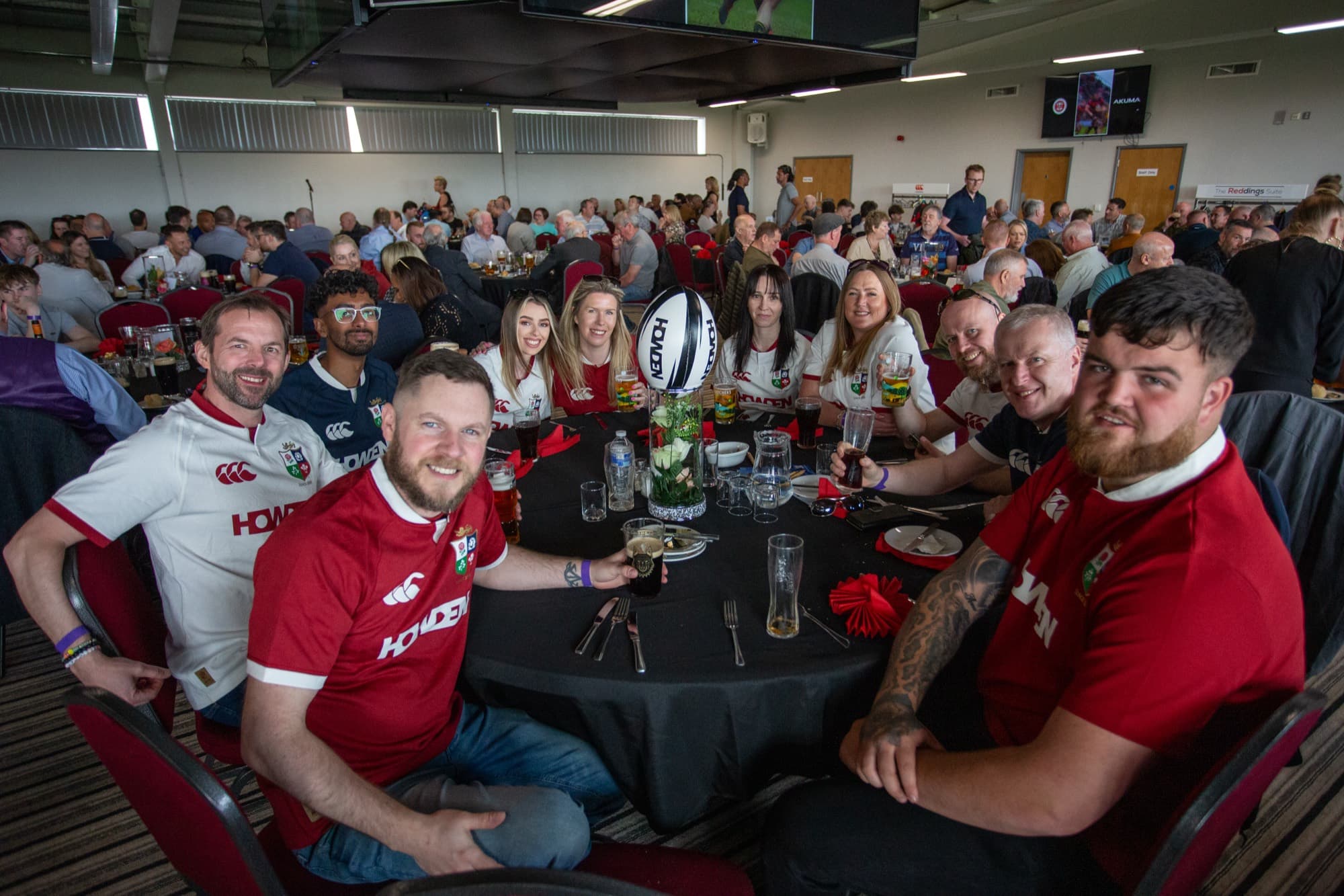 A group of guests in rugby shirts enjoying match-day hospitality at The Reddings Suite, Birmingham