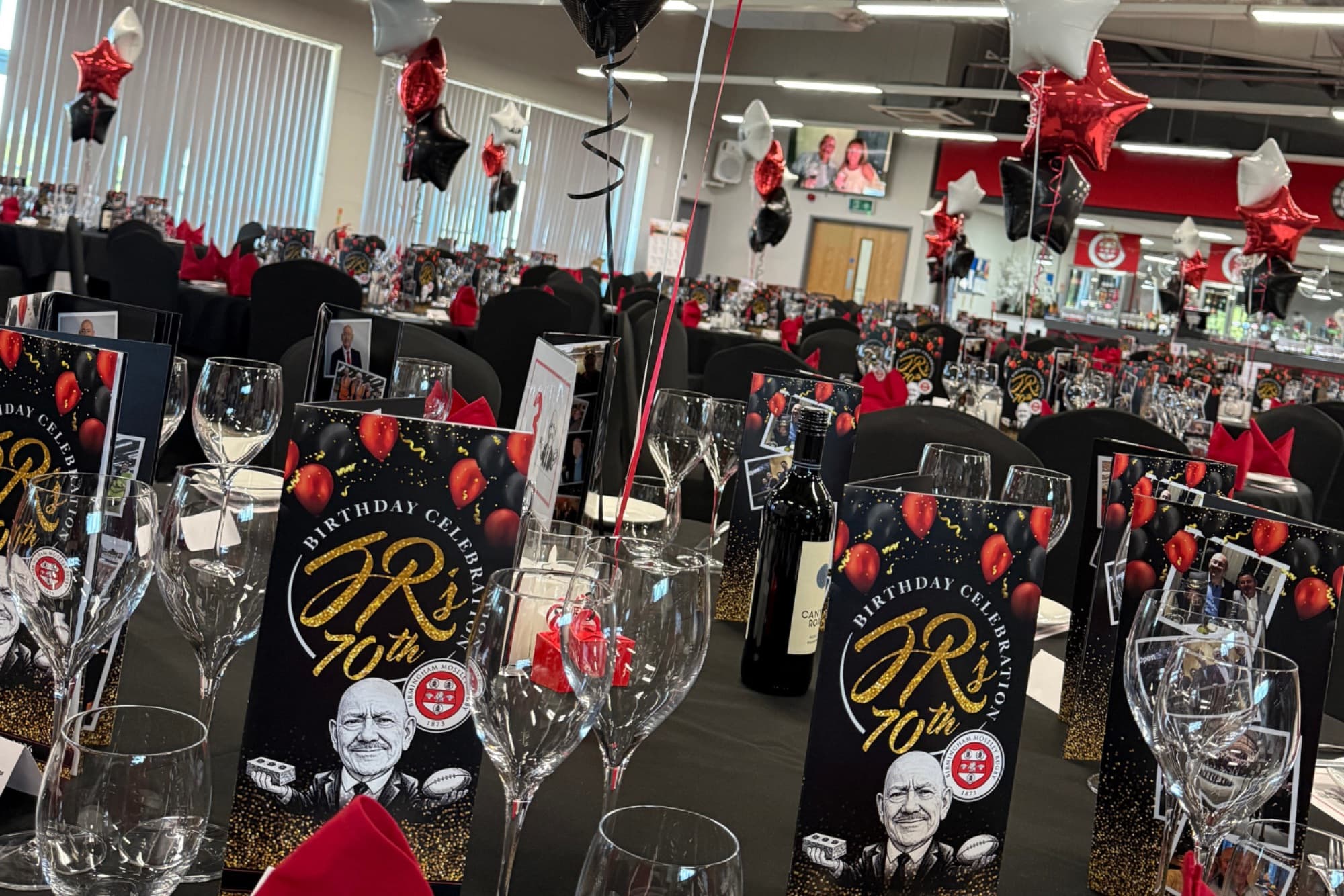 Tables dressed in red, black and gold for a private birthday celebration