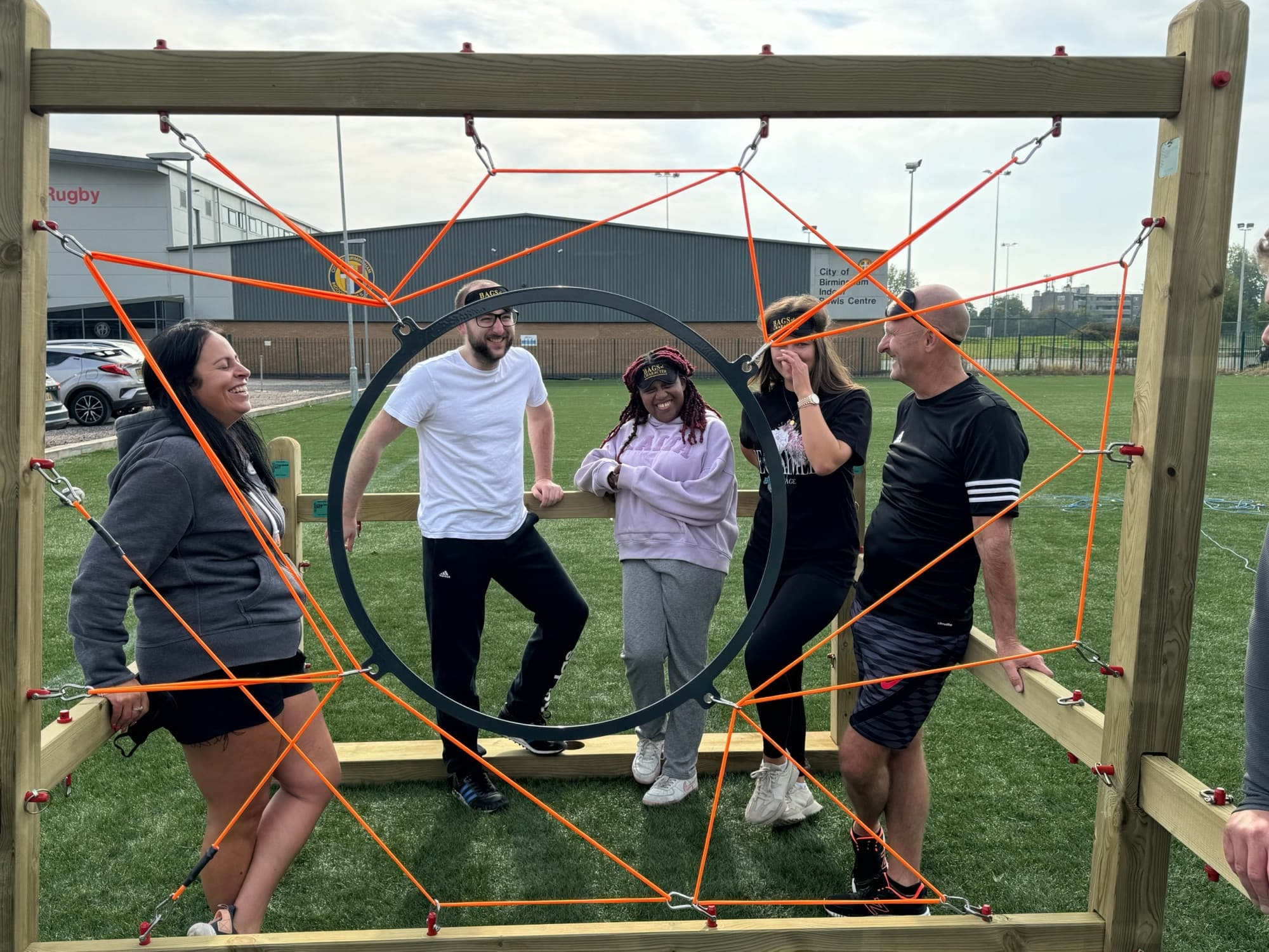 A group taking part in a team-building activity on the grounds at the sporting village